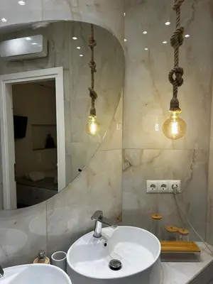 a bathroom with a sink and a mirror at Hephaestus by Heloni Apartments in Athens