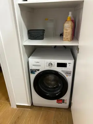 a washer and dryer in a white closet at Hephaestus by Heloni Apartments in Athens