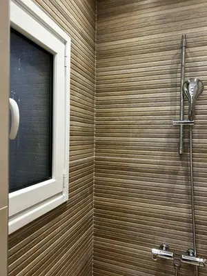 a bathroom with a shower with a window at Hephaestus by Heloni Apartments in Athens