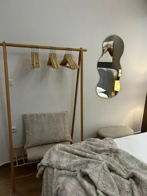 a bedroom with a bed and a chair and a guitar at Hephaestus by Heloni Apartments in Athens