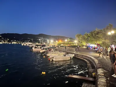a group of boats in the water at night at Ioli Seafront Hideaway by Porto Rafti Marina in Porto Rafti