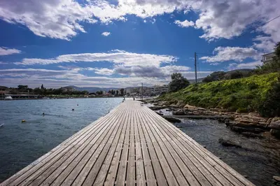 a wooden bridge over a body of water at Ioli Seafront Hideaway by Porto Rafti Marina in Porto Rafti
