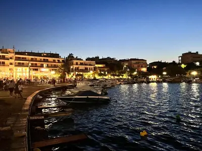 a group of boats docked in a river at night at Ioli Seafront Hideaway by Porto Rafti Marina in Porto Rafti