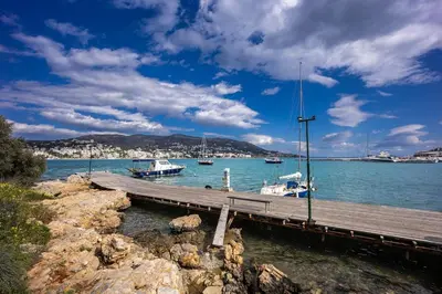 a dock with boats in a body of water at Ioli Seafront Hideaway by Porto Rafti Marina in Porto Rafti