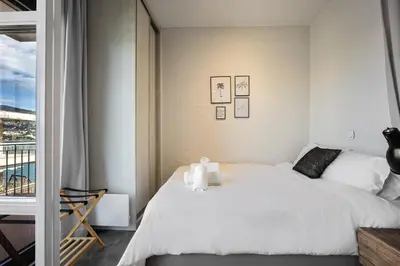 a bedroom with a bed with two towels on it at Ioli Seafront Hideaway by Porto Rafti Marina in Porto Rafti
