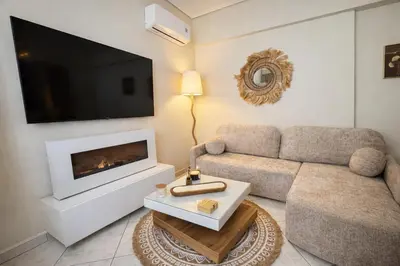 a living room with a couch and a fireplace at Like a Royal - Luxury Boho Apartment in Glyfada in Athens