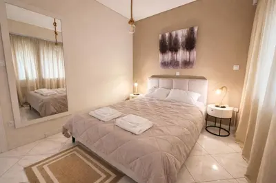 a bedroom with a large bed with two towels on it at Like a Royal - Luxury Boho Apartment in Glyfada in Athens