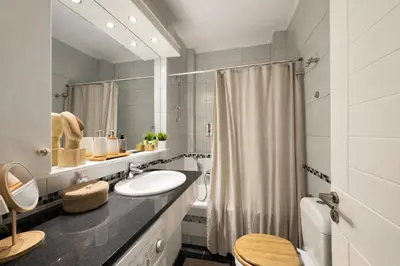 a bathroom with a sink and a mirror at Like a Royal - Luxury Boho Apartment in Glyfada in Athens