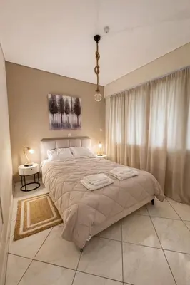 a bedroom with a large bed and a window at Like a Royal - Luxury Boho Apartment in Glyfada in Athens