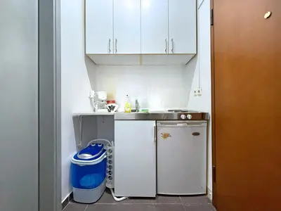 a small kitchen with a sink and a trash can at Charming and cozy studio apartment in Athens