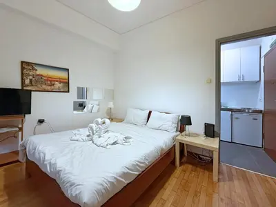 a bedroom with a bed with a teddy bear on it at Charming and cozy studio apartment in Athens