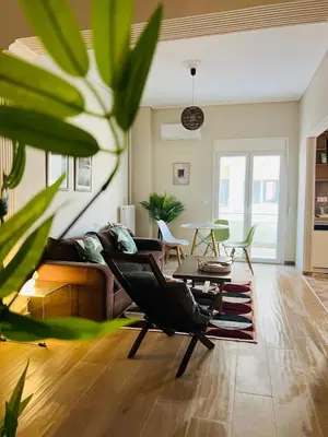a living room with a couch and chairs and a table at BoraBora Flat in Piraeus