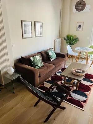 a living room with a couch and a table at BoraBora Flat in Piraeus