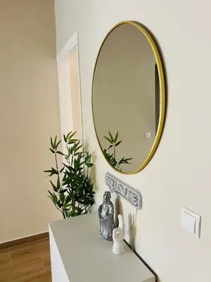 a mirror sitting on top of a dresser in a room at BoraBora Flat in Piraeus