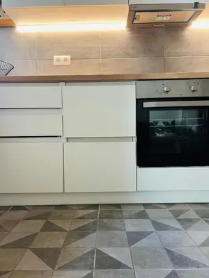 a kitchen with white cabinets and an oven at BoraBora Flat in Piraeus