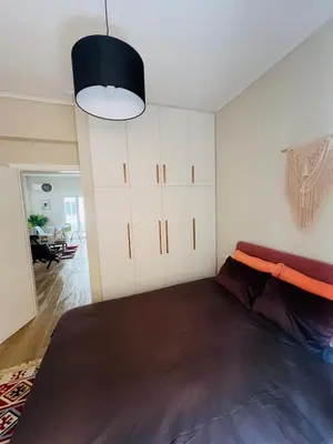 a bedroom with a large bed in a room at BoraBora Flat in Piraeus