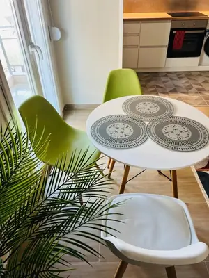 a kitchen with a table and chairs and a plant at BoraBora Flat in Piraeus