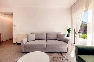 a living room with a couch and a table at Boutique17 Luxury Apartment Ground Floοr in Athens