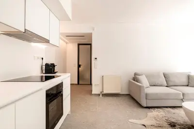 a living room with a couch and a kitchen at Boutique17 Luxury Apartment Ground Floοr in Athens