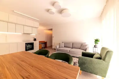 a kitchen and living room with a table and chairs at Boutique17 Luxury Apartment Ground Floοr in Athens