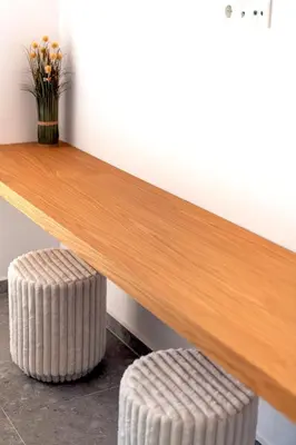 a wooden bench with two stools under it at Boutique17 Luxury Apartment Ground Floοr in Athens