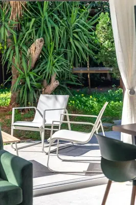 a group of chairs sitting on a patio at Boutique17 Luxury Apartment Ground Floοr in Athens