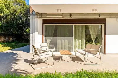 a group of chairs and a table on a patio at Boutique17 Luxury Apartment Ground Floοr in Athens