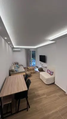 a living room with a table and a couch at Beige House in Saronida
