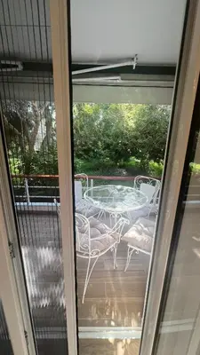 a view of a patio with a table and chairs at Beige House in Saronida