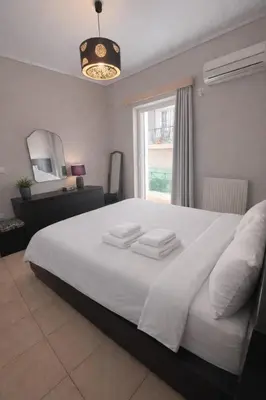 a bedroom with a large white bed with a window at Bright & Spacious 80sqm Apartment Glyfada,Balcony in Athens