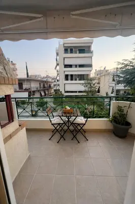 a patio with a table and chairs on a balcony at Bright & Spacious 80sqm Apartment Glyfada,Balcony in Athens