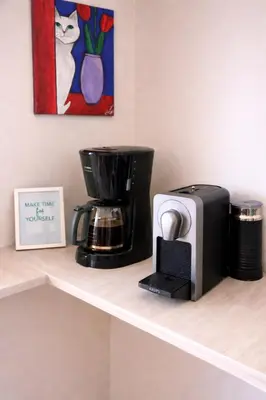 a shelf with a coffee maker and a coffeemaker on it at Bright & Spacious 80sqm Apartment Glyfada,Balcony in Athens