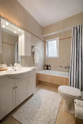 a bathroom with a sink and a tub and a toilet at Bright & Spacious 80sqm Apartment Glyfada,Balcony in Athens