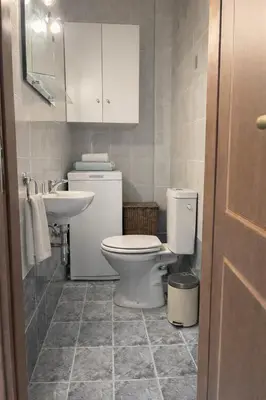 a bathroom with a toilet and a sink at Bright & Spacious 80sqm Apartment Glyfada,Balcony in Athens