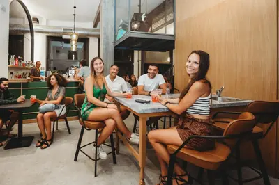 a group of people sitting at a table in a restaurant at Athens Backpackers in Athens