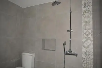 a bathroom with a shower with a toilet in it at Varkiza's Cottages in Varkiza