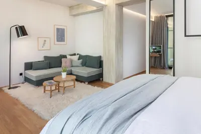 a bedroom with a large bed and a couch at Coco-Mat Hotel Athens in Athens