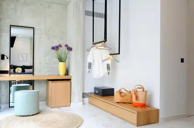a room with a mirror and a table with bags at Coco-Mat Hotel Athens in Athens