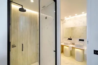 a bathroom with a shower and two sinks at Coco-Mat Hotel Athens in Athens