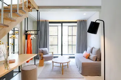 a living room with a couch and a table at Coco-Mat Hotel Athens in Athens