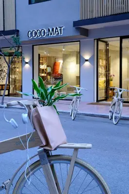 a bike parked in front of a store with a plant at Coco-Mat Hotel Athens in Athens