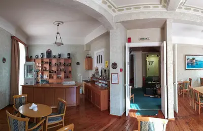 a kitchen and dining room with a table and chairs at Cecil Hotel in Athens