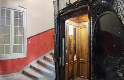 a staircase leading up to a wooden door in a house at Cecil Hotel in Athens