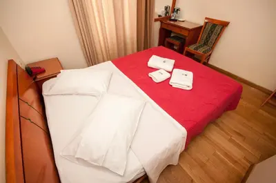 a bedroom with a bed with two towels on it at Cecil Hotel in Athens
