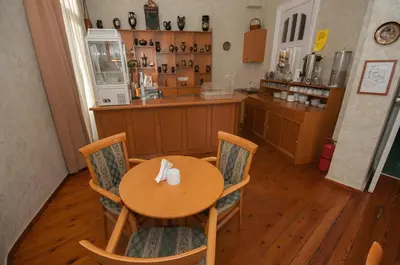 a table and chairs in a kitchen with a counter at Cecil Hotel in Athens
