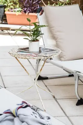 a table with a plant on it next to a chair at Concierge Monastiraki in Athens