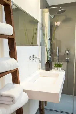 a bathroom with a white sink and a shower at Concierge Monastiraki in Athens