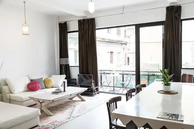 a living room with a white couch and a table at Concierge Monastiraki in Athens