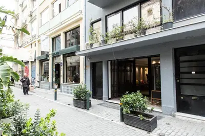 a building with potted plants on a city street at Concierge Monastiraki in Athens