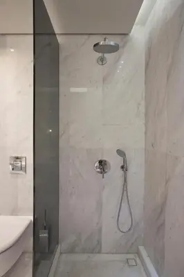 a bathroom with a shower with a glass door at MET34 Athens in Athens